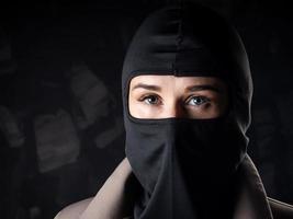 Portrait of a girl in a black balaclava and beige coat. photo