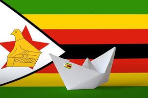 Zimbabwe flag depicted on paper origami ship closeup. Handmade arts concept photo