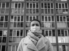 Shot of a girl in a mask, on the street. lockdown Covid-19 pandemic. photo