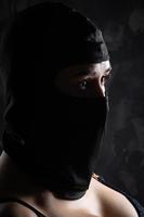 Portrait of a girl in a black balaclava and a black bra. photo