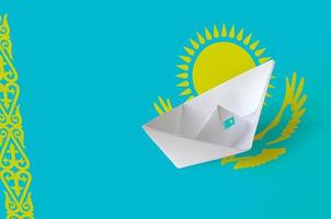 Kazakhstan flag depicted on paper origami ship closeup. Handmade arts concept photo