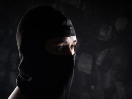 Portrait of a girl in a black balaclava and a black bra. photo