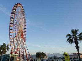 Ferris wheel against the sky. Amusement park on the sea. Rest zone. photo