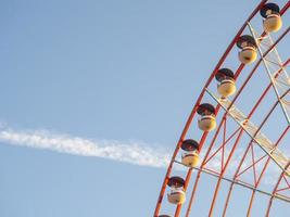 Ferris wheel against the sky. Amusement park by the sea. Rest zone. Round mechanism. Height lovers. photo