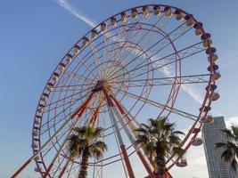 Ferris wheel against the sky. Amusement park on the sea. Rest zone. Ferris wheel. Round mechanism photo