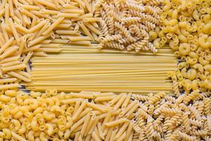 Raw pasta various kinds of uncooked pasta macaroni spaghetti and noodles on wooden, Italian food culinary concept, Collection of different raw pasta on cooking table for cooking food photo