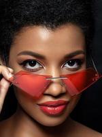 Young beautiful black woman wearing red sunglasses photo