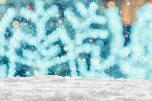 Empty white snow with blur Christmas tree with bokeh light background photo