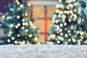 Empty white snow with blur Christmas tree with bokeh light background photo