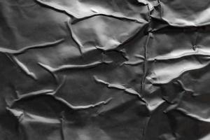 fondo de textura de cartel de plástico negro arrugado y arrugado foto