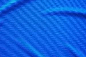 Blue football jersey clothing fabric texture sports wear background, close up top view photo