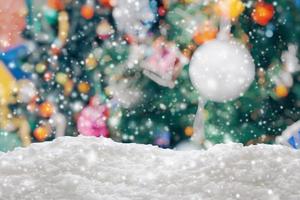 Empty white snow with blur Christmas tree with bokeh light background photo