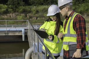 Environmental engineers work at wastewater treatment plants,Water supply engineering working at Water recycling plant for reuse,Technicians and engineers discuss work together. photo