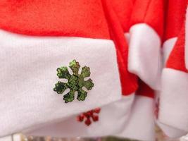 fondo de navidad, sombreros de santa claus con adornos de nieve roja vendidos en tiendas de suministros de navidad foto