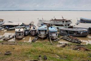 Manacapuru, Amazonas, Brazil November 18 2022 Boats docked along the Solimoes, Amazon River in Manacapuru some waiting to be repaired photo