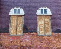 Old church window and wall, Windows made of wood The upper window sill is a semicircular arch. The wall is made of bricks. Soft and selective focus. photo