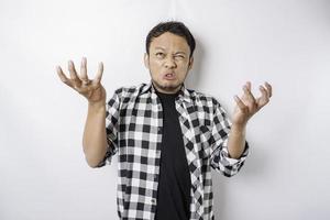 The angry and mad face of Asian man in tartan shirt on isolated white background. photo