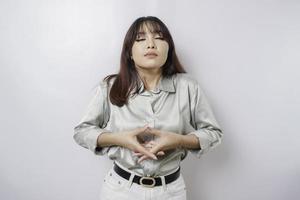 Portrait of a casual pretty woman meditating on white background. Stress free relief at work concept, peaceful young woman practicing breathing yoga exercise photo