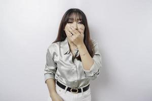 A portrait of an Asian woman wearing a sage green shirt isolated by white background looks depressed photo