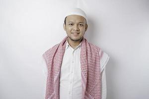 A portrait of a happy Asian Muslim man smiling isolated by white background photo