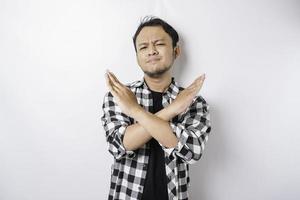 Handsome Asian man with hand gesture pose rejection or prohibition with copy space photo