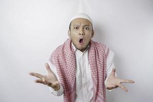 A portrait of a shocked Asian Muslim man isolated by a white background photo