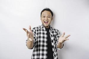 A portrait of a happy Asian man wearing tartan shirt is smiling isolated by white background photo