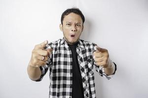 The angry and mad face of Asian man in tartan shirt on isolated white background. photo