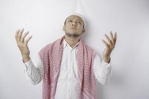 Happy handsome Asian Muslim man is praying to God. photo