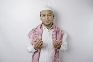Happy handsome Asian Muslim man is praying to God. photo