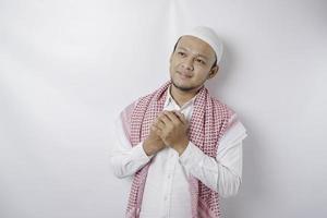 Portrait of a peaceful Asian Muslim man smiling and feel relief photo