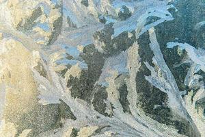 Frozen winter window with shiny ice frost pattern texture. Christmas wonder symbol, abstract background. Extreme north low temperature, natural Ice snow on frosty glass, cool winter weather outdoor. photo