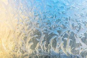 Frozen winter window with shiny ice frost pattern texture. Christmas wonder symbol, abstract background. Extreme north low temperature, natural Ice snow on frosty glass, cool winter weather outdoor. photo