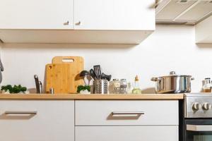 Scandinavian classic minimalistic kitchen with white and wooden details. Modern white kitchen clean contemporary style interior design. photo