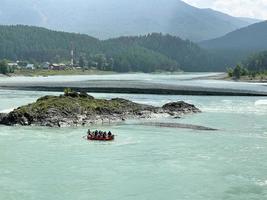 People on a catamaran are rafting down the Katun River, Altai, Russia photo