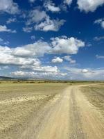 Country road in the steppe in a cloudy day, Altai, Russia photo