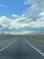 The road goes into the distance in the mountains, a part of the Chuisky tract , Altai, Russia photo