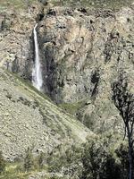 High nameless waterfall in Chulyshman valley, Altai, Russia photo