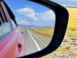 Mountain landscape reflected in the rearview mirror photo