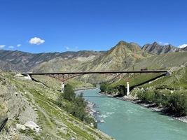 Bridge across the Katun river in the Inya village, Altai, Russia photo