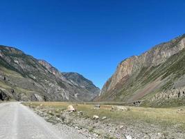 The road goes into the distance in the mountains, Altai, Russia photo