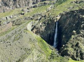 High nameless waterfall in Chulyshman valley, Altai, Russia photo