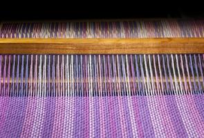 detail of fabric in comb loom with ultraviolet and lilac colors photo