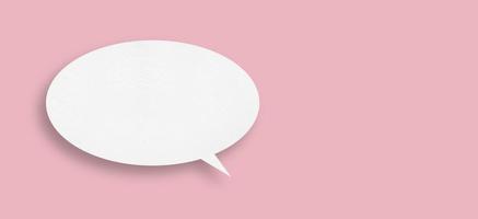 Round white paper with speech bubbles isolated on pink background communication bubble . photo