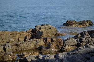 At the sea, rocks and water photo