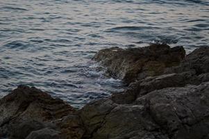 Croatia beach, rocks at the beach, sea water, waves photo