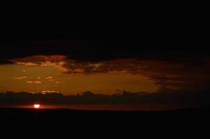 Sunset in nature, big clouds, orange light photo