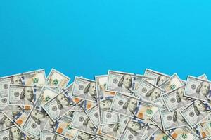One hundred dollar banknotes on colored background top view, with empty place for your text business money concept. One hundred dollar background. photo