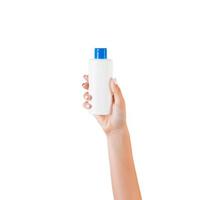 Female hand holding cream bottle of lotion isolated. Girl give cosmetic products on white background photo