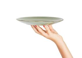 Hand holding green empty plate isolated on white background. perspective view, isolated on white background photo